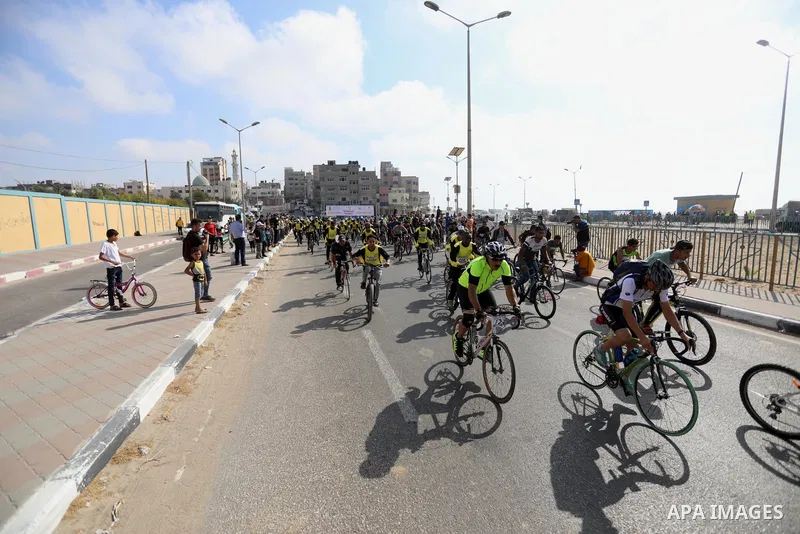 Palestinians take part in a bike race championship including disabled people, in Gaza city, on June 30, 2021. Photo by Ashraf Amra