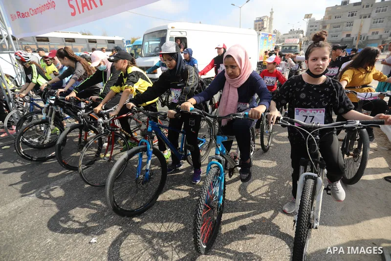 Palestinians take part in a bike race championship including disabled people, in Gaza city, on June 30, 2021. Photo by Ashraf Amra