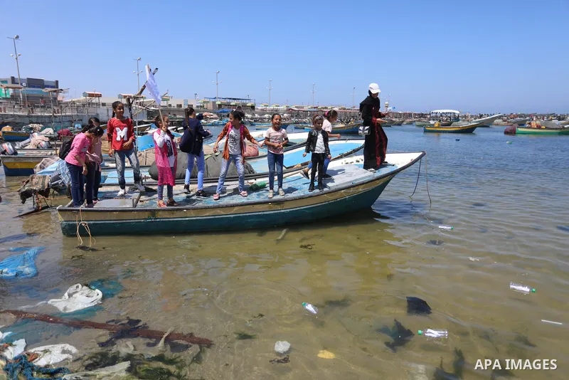 Palestinian children hold helium balloons as they take part in a rally, in the Gaza port, on June 30, 2021. Children from Gaza send messages to the countries of the world, expressing their wishes and aspirations to respe...