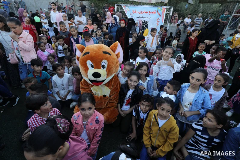 Palestinian children participate in a mental health support session during entertainment festival after the latest Israeli escalation, in Rafah in the southern Gaza Strip, on June 25, 2021. Photo by Abed Deeb