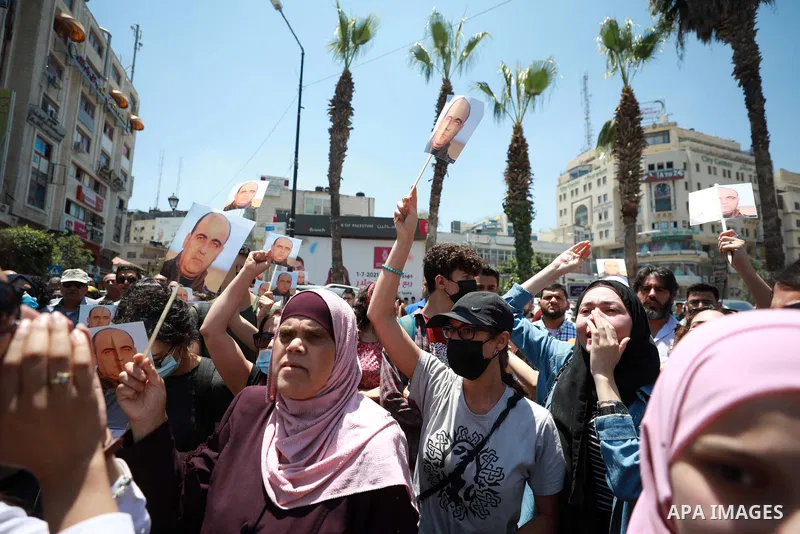 Demonstrators gather during a protest following the death of Palestinian parliamentary candidate and activist Nizar Banat, who died after being arrested by Palestinian Authority's security forces, in the West Bank city o...