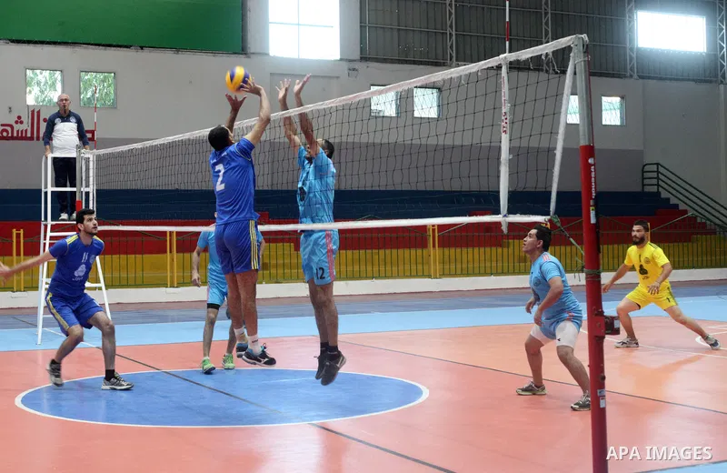 Palestinian players of Shabab Jabalia team and players of al-Karama team in actions during Volleyball match in Gaza city on June 22, 2021. Photo by Ali Hamad