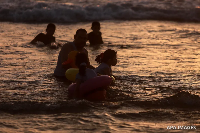 Palestinians enjoy the beach of the Mediterranean sea in Gaza City, on June 11, 2021. The beach is one of the few open public spaces in this densely populated city. Photo by Mohammed Dahman