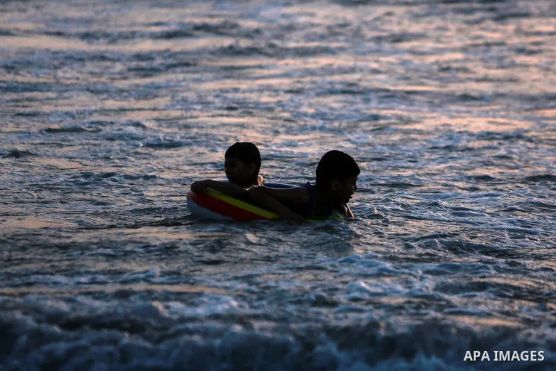 Palestinians enjoy the beach of the Mediterranean sea in Gaza City, on June 11, 2021. The beach is one of the few open public spaces in this densely populated city. Photo by Mohammed Dahman