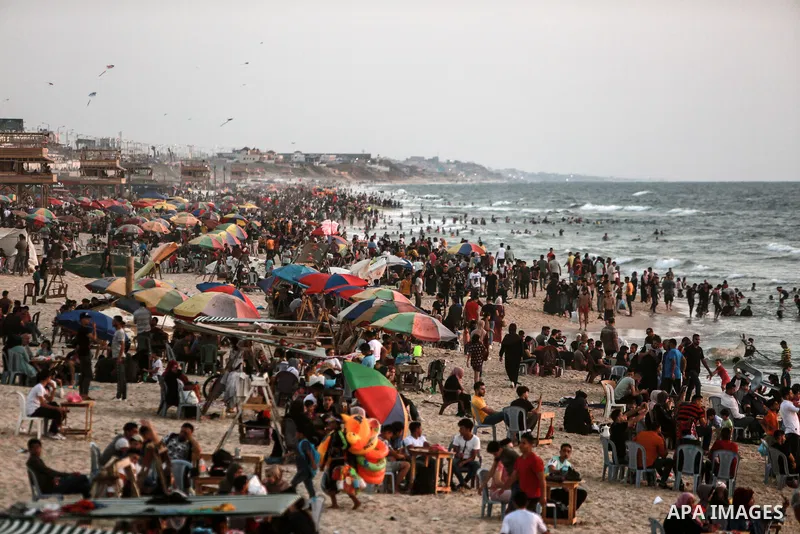 Palestinians enjoy the beach of the Mediterranean sea in Gaza City, on June 11, 2021. The beach is one of the few open public spaces in this densely populated city. Photo by Mohammed Dahman