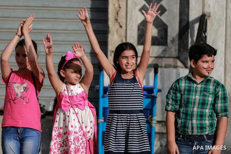 Palestinian children cheer during a mental health support session by Palestinian clowns in Gaza city on June 11, 2021. As Gaza tries to recover from the deadly 11-day Israeli attack, mothers and mental health workers hav...