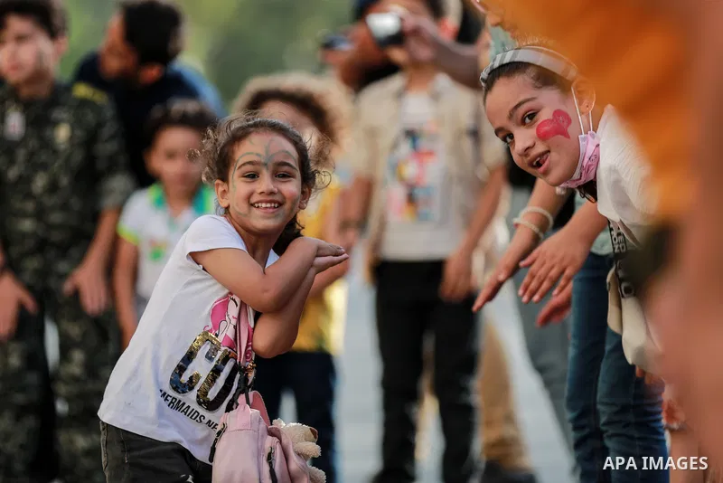 Palestinian children cheer during a mental health support session by Palestinian clowns in Gaza city on June 11, 2021. As Gaza tries to recover from the deadly 11-day Israeli attack, mothers and mental health workers hav...