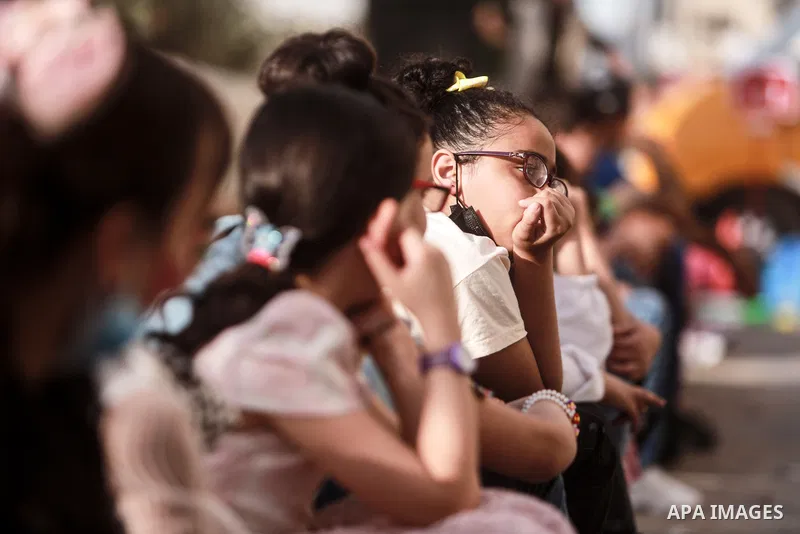 Palestinian children cheer during a mental health support session by Palestinian clowns in Gaza city on June 11, 2021. As Gaza tries to recover from the deadly 11-day Israeli attack, mothers and mental health workers hav...