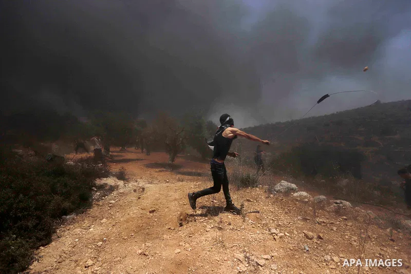 Palestinian protesters clash with Israeli security forces following a demonstration against Israeli settlement in the village of Beita, south of Nablus, in the West Bank on June 11, 2021. Photo by Shadi Jarar'ah