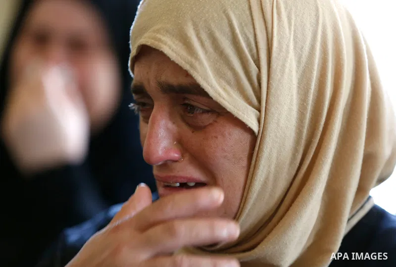 A relative of Palestinian security man Adham Alioh, who was killed by Israeli forces according to health ministry, reacts during his funeral in the West Bank city of Nablus on June 10, 2021. Photo by Shadi Jarar'ah