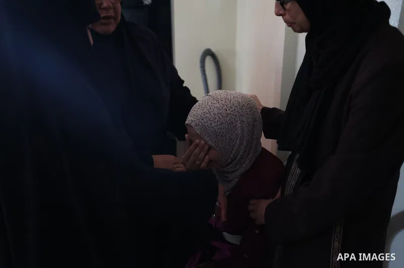Relatives of Palestinian boy Obaida Dahdoh, who was killed by unexploded projectiles, mourn as they gather around his body during his funeral in Gaza City on June 10, 2021. Photo by Osama Baba