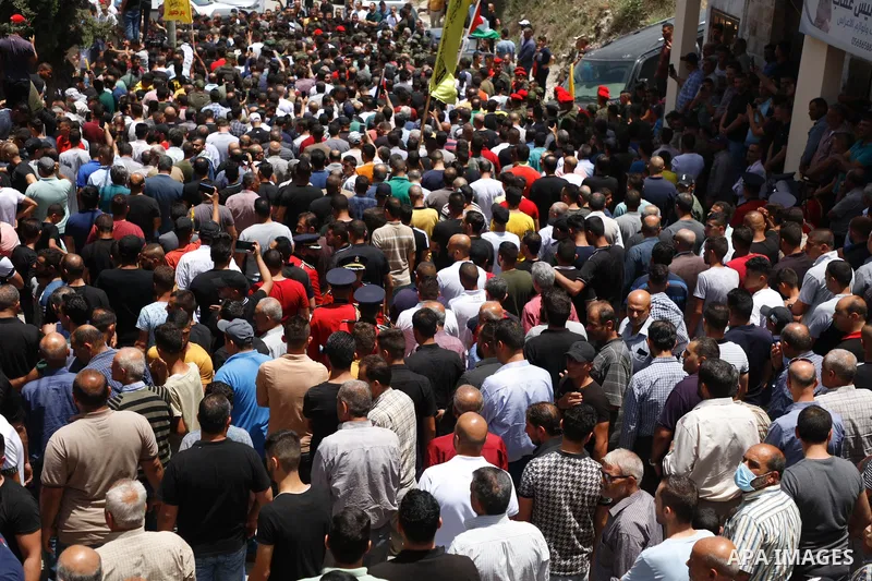 Mourners carry the body of Palestinian security man Tayseer Issa, who was killed by Israeli forces according to health ministry, during his funeral in the Werst bank city of Jenin, on June 10, 2021. Photo by Oday Daibes
