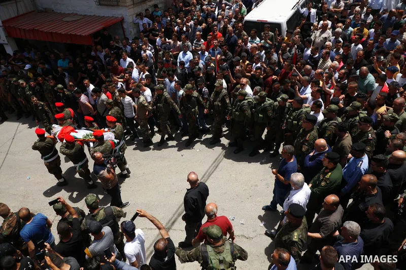 Mourners carry the body of Palestinian security man Tayseer Issa, who was killed by Israeli forces according to health ministry, during his funeral in the Werst bank city of Jenin, on June 10, 2021. Photo by Oday Daibes