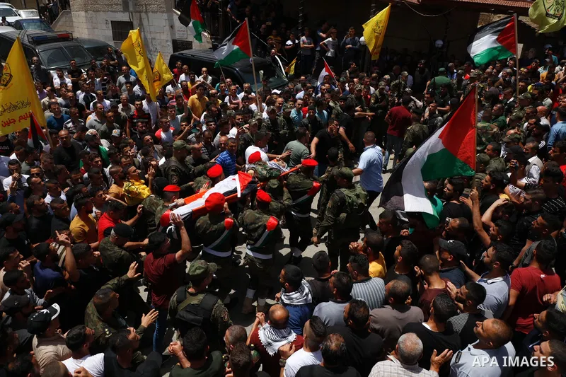 Mourners carry the body of Palestinian security man Tayseer Issa, who was killed by Israeli forces according to health ministry, during his funeral in the Werst bank city of Jenin, on June 10, 2021. Photo by Oday Daibes