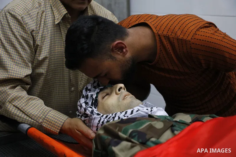 Mourners carry the body of Palestinian security man Tayseer Issa, who was killed by Israeli forces according to health ministry, during his funeral in the Werst bank city of Jenin, on June 10, 2021. Photo by Oday Daibes