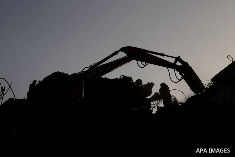 Egyptian bulldozers sent from Egypt help to remove the rubble of Shorouq tower destroyed by Israeli air strikes last month in Gaza city on June 9, 2021. After brokering a ceasefire between the Israelis and Hamas movement...