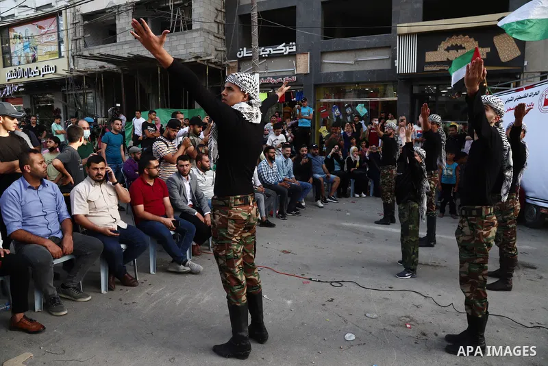 Palestinian Dabka band perform during an event "With blood, we write for Palestine" near the rubble of Shorouq tower destroyed by Israeli air strikes last month, in Gaza city on June 9, 2021. The Egyptian-brokered truce...