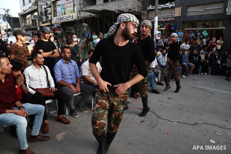 Palestinian Dabka band perform during an event "With blood, we write for Palestine" near the rubble of Shorouq tower destroyed by Israeli air strikes last month, in Gaza city on June 9, 2021. The Egyptian-brokered truce...