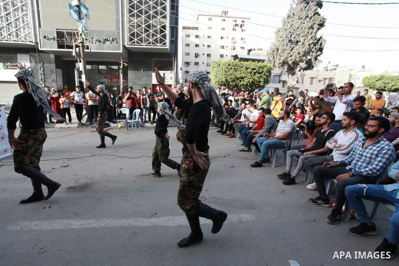 Palestinian Dabka band perform during an event "With blood, we write for Palestine" near the rubble of Shorouq tower destroyed by Israeli air strikes last month, in Gaza city on June 9, 2021. The Egyptian-brokered truce...