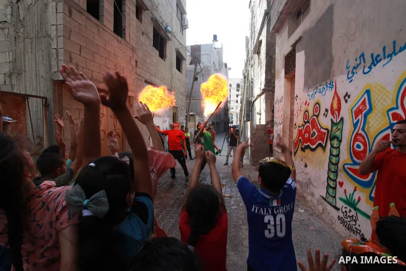 Palestinian children cheer during a mental health support session by Palestinian volunteers through acrobatic performances in Gaza city on June 9, 2021. As Gaza tries to recover from the deadly 11-day Israeli attack, mot...