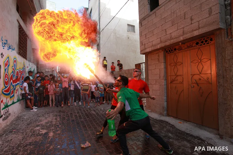 Palestinian volunteers perform acrobatic show in front of children during a mental health support session in Gaza city on June 9, 2021. As Gaza tries to recover from the deadly 11-day Israeli attack, mothers and mental h...