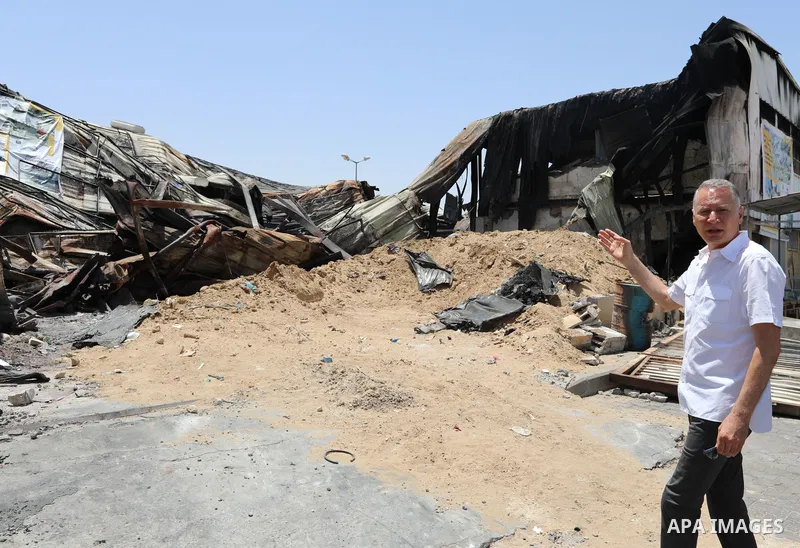 Palestinian businessman and Head of the Board of Directors of "PADICO Holding", Bashar Al-Masry, visits the factories damaged in Gaza's industrial area, which was hit by Israeli strikes, in Gaza city on June 09, 2021. Ga...