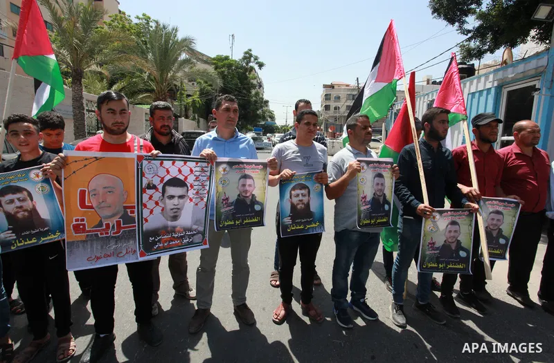 Palestinians take part in a solidarity with the two prisoners on hunger strike, the leader of the Islamic Jihad movement, Khader Adnan and Al-Ghazanfar Abu Atwan, in front of the headquarters of the High Commissioner in...