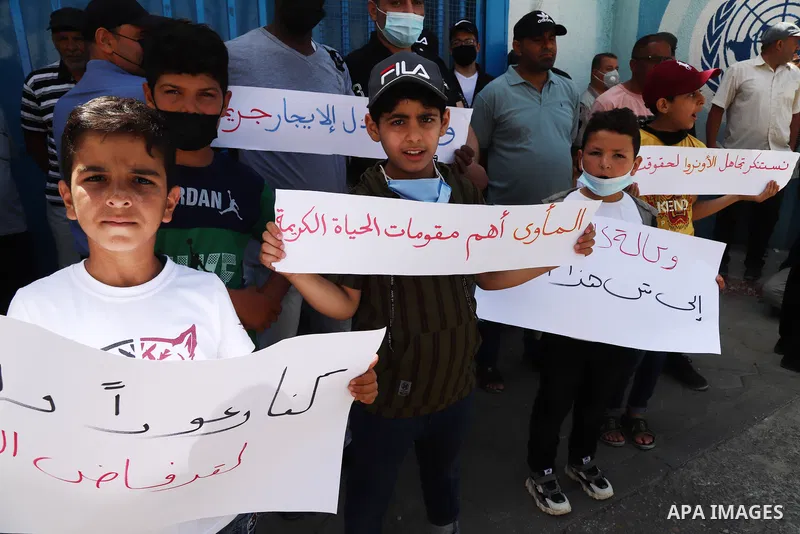 Palestinian refugees from Syria take part in a protest to demand their rights in front of the headquarters United Nations Relief and Works Agency (UNRWA), in Gaza City on June 9, 2021.There are currently 54 families with...