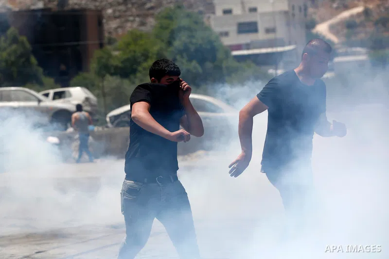 Palestinian youths clash with Israeli security forces against Israeli settlements in the village of Beita, south of Nablus, in the occupied West Bank on June 8, 2021. Photo by Shadi Jarar'ah