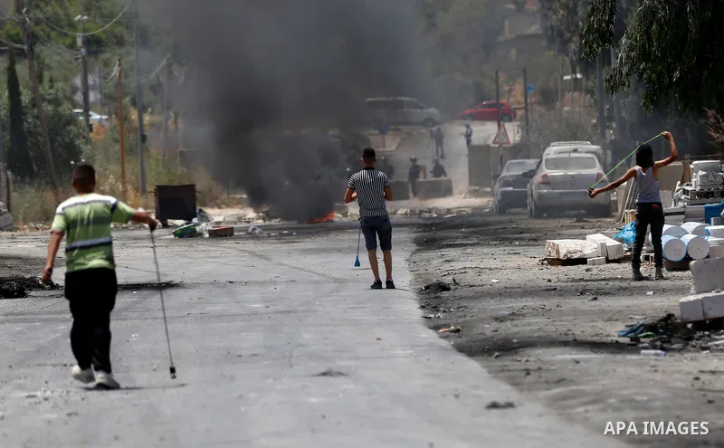 Palestinian youths clash with Israeli security forces against Israeli settlements in the village of Beita, south of Nablus, in the occupied West Bank on June 8, 2021. Photo by Shadi Jarar'ah
