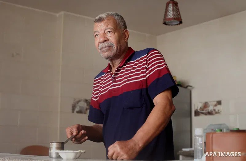 Palestinian Mohammad Al-Rawagh, 68, massages a man with olive oil, during a treatment session, at his home in Gaza ctiy on June 8, 2021. Massages are a type of complementary or alternative therapy. They’re not considered...
