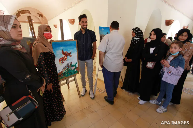 Palestinians attend an exhibition entitled "dirt and stones" at the Arts and Crafts Village in Gaza City, on June 8, 2021. Gaza’s housing ministry said on Thursday that 16,800 housing units had been damaged. Of those, 1,...