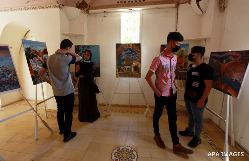 Palestinians attend an exhibition entitled "dirt and stones" at the Arts and Crafts Village in Gaza City, on June 8, 2021. Gaza’s housing ministry said on Thursday that 16,800 housing units had been damaged. Of those, 1,...