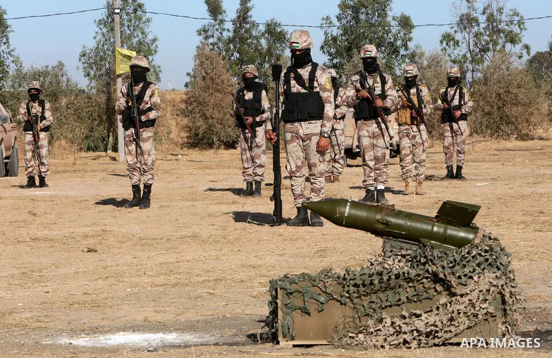 Palestinian militants of Al-Aqsa Martyrs' Brigades, the armed wing of Fatah movement take part in a military parade in an anti-Israel rally, in Khan Younis in the southern of Gaza Strip June 7, 2021. Photo by Abed Deeb