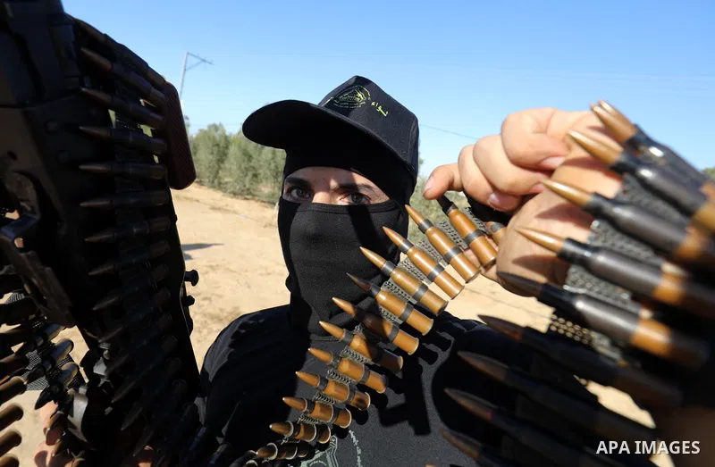 Palestinian militants of Al-Aqsa Martyrs' Brigades, the armed wing of Fatah movement take part in a military parade in an anti-Israel rally, in Khan Younis in the southern of Gaza Strip June 7, 2021. Photo by Abed Deeb