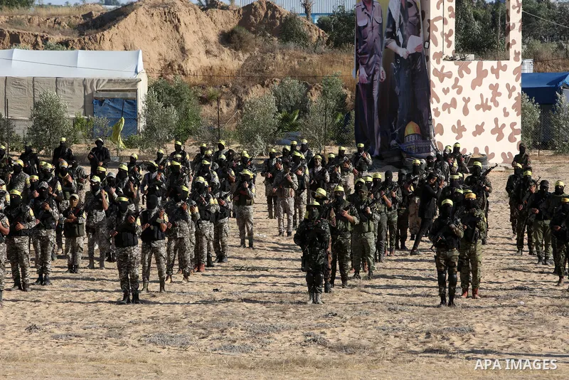 Palestinian militants of Al-Aqsa Martyrs' Brigades, the armed wing of Fatah movement take part in a military parade in an anti-Israel rally, in Khan Younis in the southern of Gaza Strip June 7, 2021. Photo by Abed Deeb