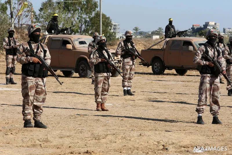 Palestinian militants of Al-Aqsa Martyrs' Brigades, the armed wing of Fatah movement take part in a military parade in an anti-Israel rally, in Khan Younis in the southern of Gaza Strip June 7, 2021. Photo by Abed Deeb