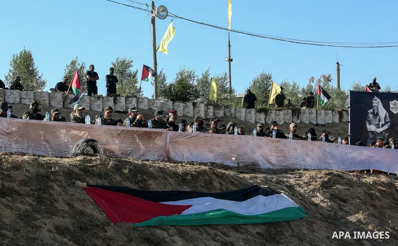 Palestinian militants of Al-Aqsa Martyrs' Brigades, the armed wing of Fatah movement take part in a military parade in an anti-Israel rally, in Khan Younis in the southern of Gaza Strip June 7, 2021. Photo by Abed Deeb