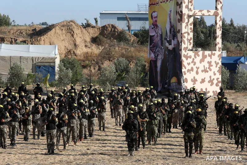 Palestinian militants of Al-Aqsa Martyrs' Brigades, the armed wing of Fatah movement take part in a military parade in an anti-Israel rally, in Khan Younis in the southern of Gaza Strip June 7, 2021. Photo by Abed Deeb