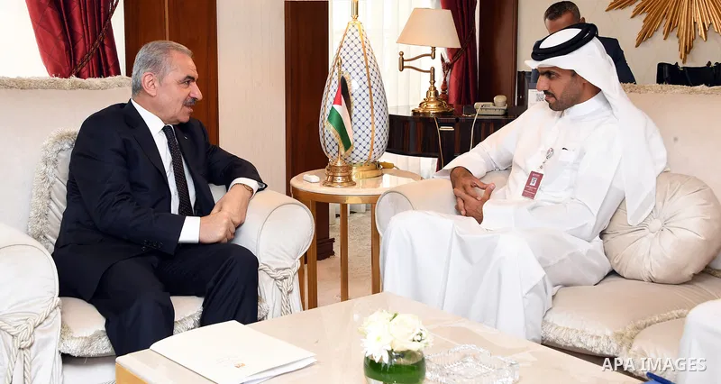 Palestinian Prime Minister Mohammad Ishtayeh meets with Director General of the Qatar Fund for Development, Khalifa bin Jassim Al-Kuwari, in the Qatari capital, Doha on June 7, 2021. Photo by Prime Minister Office
