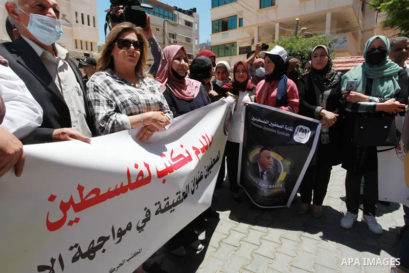Palestinian journalists take part in the protest against the dismissal of Head of the PJS, Nasser Abu Bakr from his job, in front of the Agence France Press (AFP) office, in Gaza city on June 7, 2021. Abu Bakr, who has w...