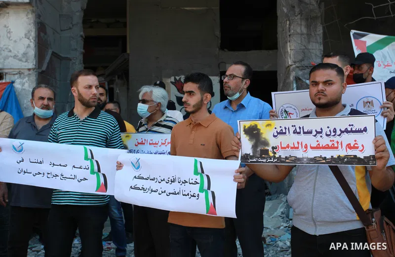 The Palestinian Artists Association take part in a protest against the destroyed of their headquarters by Israeli air strikes in front of al-Jawhara Tower destroyed, in Gaza City on June 6, 2021. Gaza’s housing ministry...