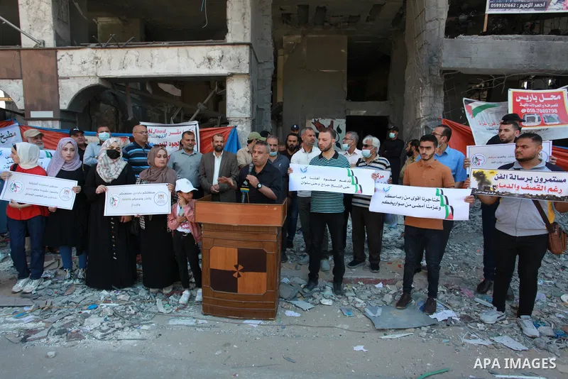 The Palestinian Artists Association take part in a protest against the destroyed of their headquarters by Israeli air strikes in front of al-Jawhara Tower destroyed, in Gaza City on June 6, 2021. Gaza’s housing ministry...