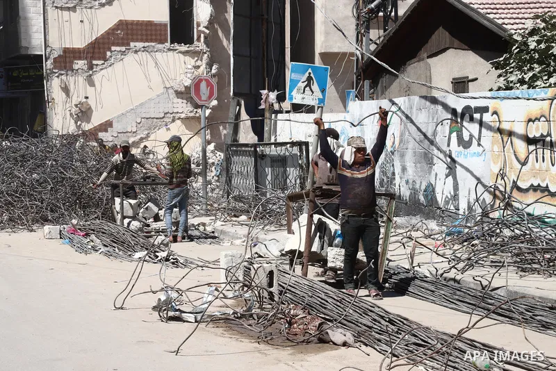 Palestinian workers straighten steel rod as part of the recycling of salvaged construction materials from buildings destroyed during the May 2021 conflict between Hamas and Israel, in Gaza City on June 5, 2021. Gaza’s ho...