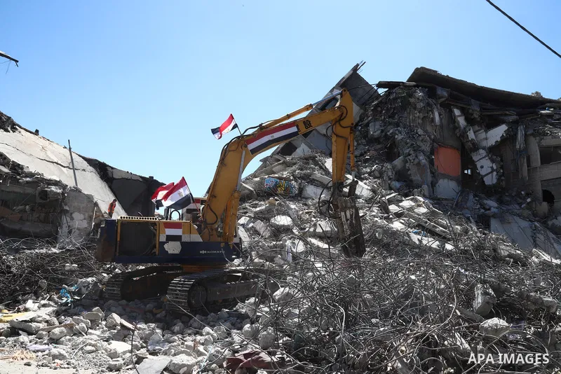 Egyptian bulldozers remove rubble from a building destroyed during the May 2021 conflict between Hamas and Israel, in Gaza City on June 5, 2021. Egypt sent an aid convoy to neighbouring Gaza with diggers, trucks and cran...