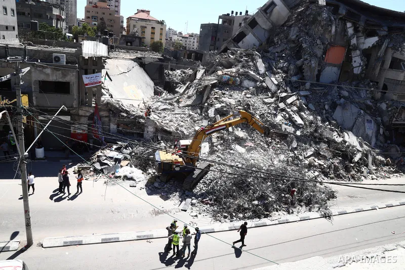 Egyptian bulldozers remove rubble from a building destroyed during the May 2021 conflict between Hamas and Israel, in Gaza City on June 5, 2021. Egypt sent an aid convoy to neighbouring Gaza with diggers, trucks and cran...