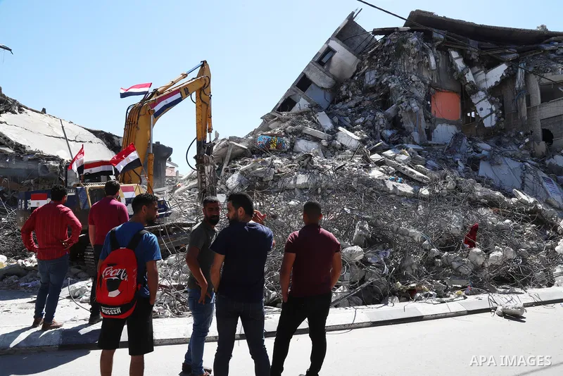 Egyptian bulldozers remove rubble from a building destroyed during the May 2021 conflict between Hamas and Israel, in Gaza City on June 5, 2021. Egypt sent an aid convoy to neighbouring Gaza with diggers, trucks and cran...