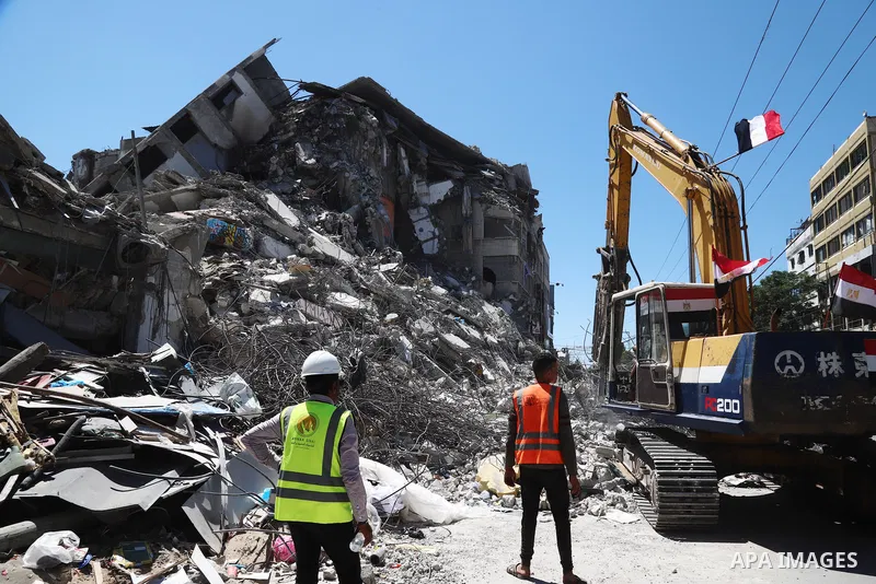 Egyptian bulldozers remove rubble from a building destroyed during the May 2021 conflict between Hamas and Israel, in Gaza City on June 5, 2021. Egypt sent an aid convoy to neighbouring Gaza with diggers, trucks and cran...