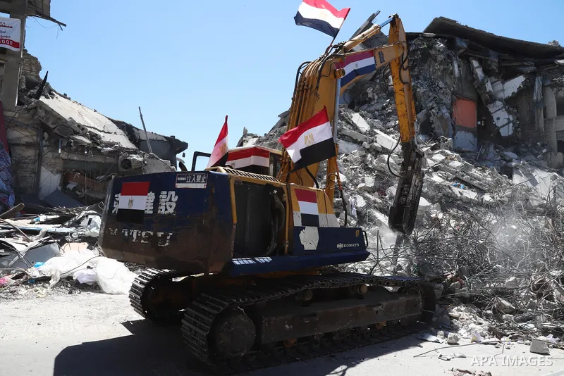 Egyptian bulldozers remove rubble from a building destroyed during the May 2021 conflict between Hamas and Israel, in Gaza City on June 5, 2021. Egypt sent an aid convoy to neighbouring Gaza with diggers, trucks and cran...