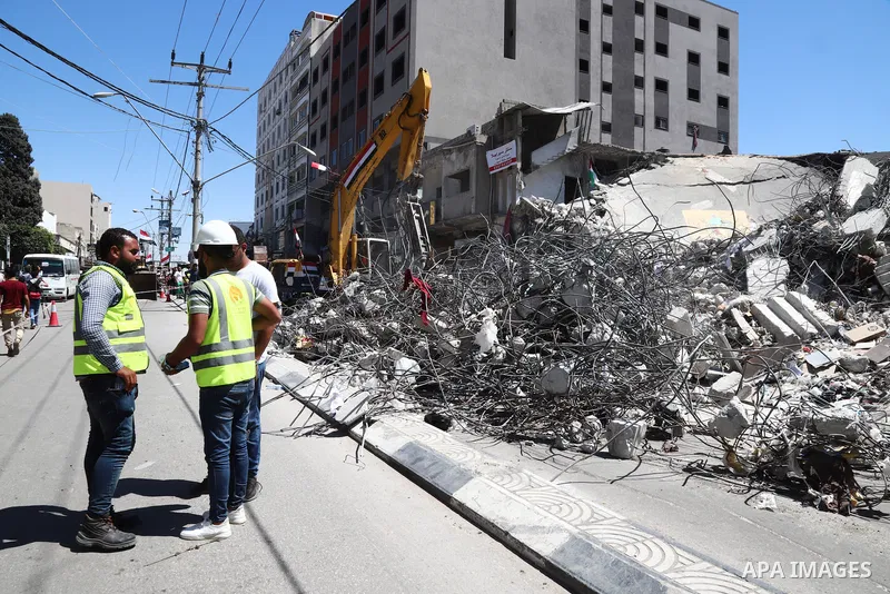 Egyptian bulldozers remove rubble from a building destroyed during the May 2021 conflict between Hamas and Israel, in Gaza City on June 5, 2021. Egypt sent an aid convoy to neighbouring Gaza with diggers, trucks and cran...